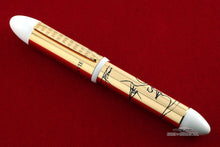 Load image into Gallery viewer, Front view of the pen on a red surface. 
