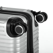 Load image into Gallery viewer, Close up to two wheels on the silver suitcase. 
