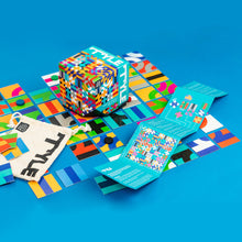 Load image into Gallery viewer, The game tiles, packaging, bag, and instructions arranged on a blue surface.
