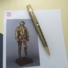 Load image into Gallery viewer, Front view of the Tudor armor rollerball pen laid on 
