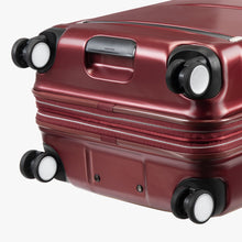 Load image into Gallery viewer, Bottom panel close up to the red suitcase. It features four spinner wheels and a grip handle. 
