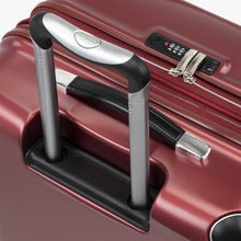 Load image into Gallery viewer, Top panel close up on the red suitcase. it features a telescopic handle, a grab handle, and a TSA approved three-digit combination lock. 

