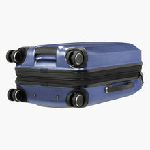 Load image into Gallery viewer, Angled bottom panel view of the slate blue suitcase. It features a grab handle on the bottom and side panels.
