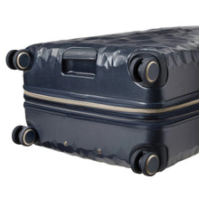 Load image into Gallery viewer, Angled bottom panel view of the navy blue suitcase, featuring a grab handle and four spinner wheels. 
