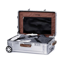 Load image into Gallery viewer, Interior view of the suitcase laid on the pack panel. The main compartment is filled with folded clothes. 
