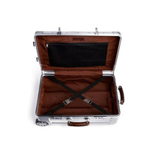 Load image into Gallery viewer, Interior view of the suitcase. The lid features a zipper-closing pocket. The main compartment a set of straps to hold contents. 
