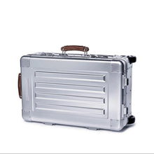 Load image into Gallery viewer, Front view of the suitcase laid on its side. The side panel features a grab handle. 

