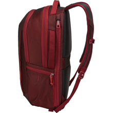 Load image into Gallery viewer, Side panel view of the ember red backpack, with the shoulder straps extended. 
