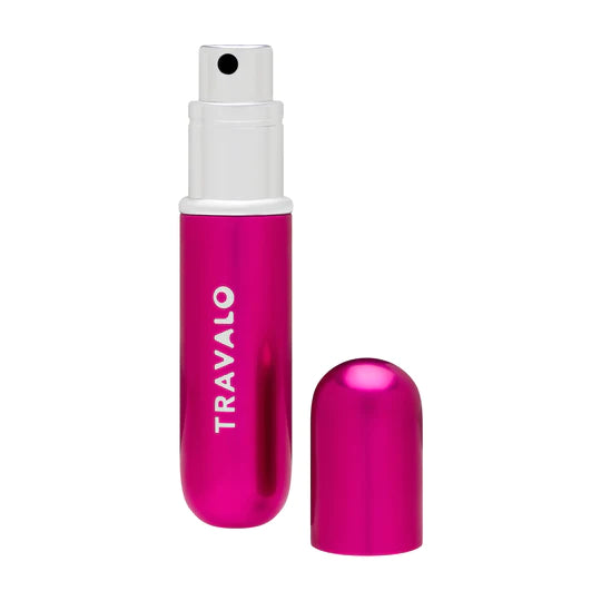 The hot pink perfume atomizer with the cap set to the side. 