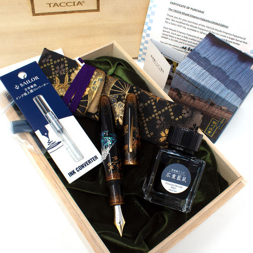 Presentation Box, Documents, Uncapped Pen, Ink bottle, Ink Converter and Pen sleeve arranged on a white background. 