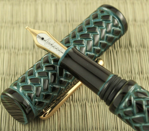 Close up to the pen's grip section resting on the cap. 