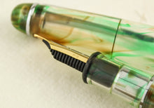 Load image into Gallery viewer, Taccia Spotlight Forest Eye Demonstrator Fountain Pen, Side View of Nib, Uncapped
