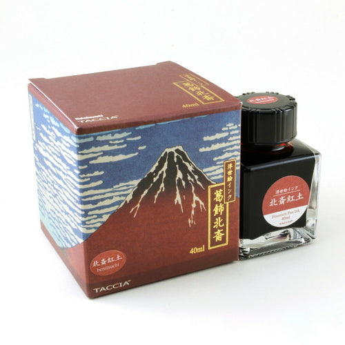 The Benituchi ink bottle and box on a white background. it is a dark red ink. 