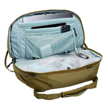 Load image into Gallery viewer, Interior view of the nutria brown duffle bag with a set of electronics stored in the pockets. The key sling shows a set of keys clipped into it. (Accessories not included).
