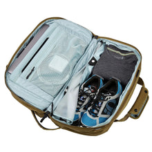 Load image into Gallery viewer, Interior view of the nutria brown backpack with electronics, clothes, and a pair of shoes arranged inside. 
