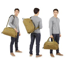 Load image into Gallery viewer, Three views of the duffle bag&#39;s carrying choices: Via shoulder strap, as a sling bag, and by the grab handles.
