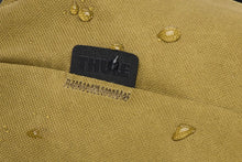 Load image into Gallery viewer, Close up to the Thule tag on the top left of the front panel. 
