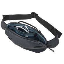 Load image into Gallery viewer, Interior view of the sling bag showing a charging cable inside a zipper-closing compartment.
