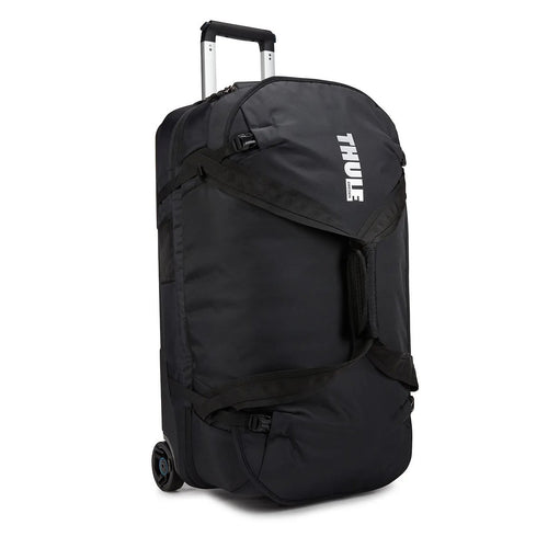 Angled front panel view of the black wheeled duffle bag. The Thule logo is printed on the front panel. 