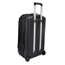 Load image into Gallery viewer, Angled back panel view of the wheeled duffle bag with the telescopic handle expanded. 

