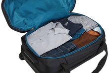 Load image into Gallery viewer, Close up to the interior filled with folded clothes.
