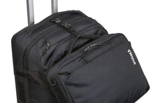 Load image into Gallery viewer, Angled close up to the suitcase&#39;s top panel featuring the attachment strap holding a briefcase.
