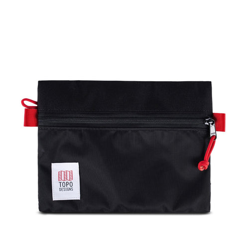 Front panel view of the medium accessory bag in black with red trims. The TOPO designs logo is on the bottom left.