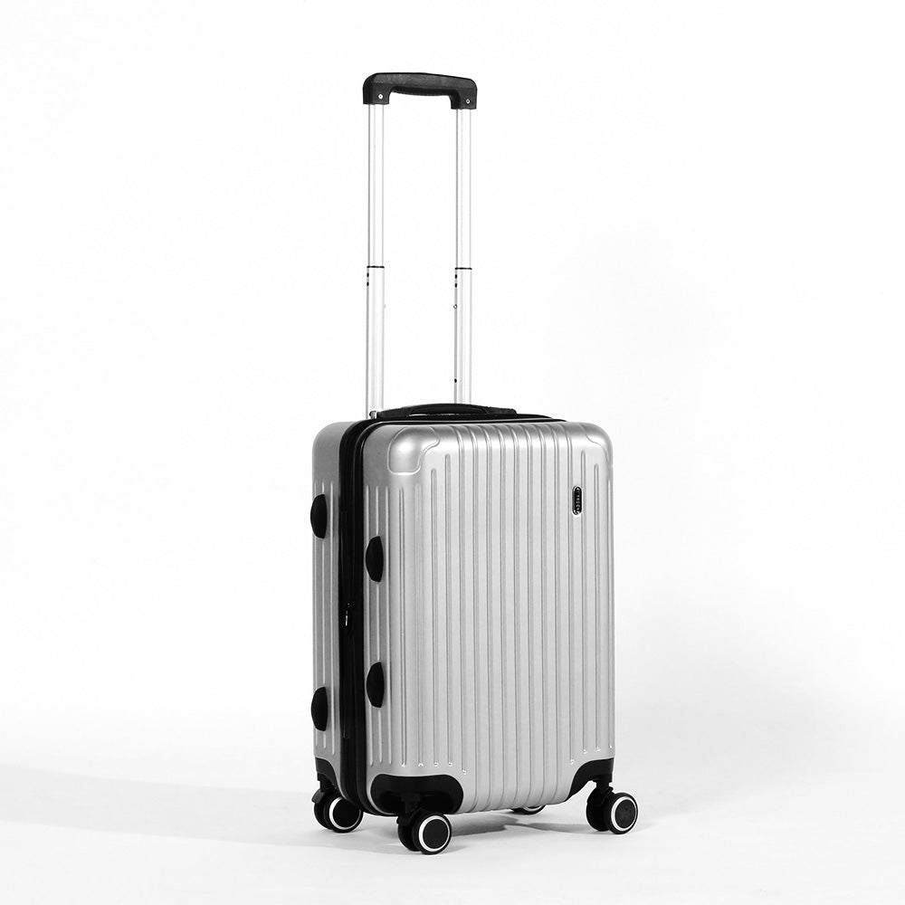 Angled front panel view of the silver colored suitcase with the telescopic handle partly extended. 