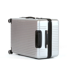 Load image into Gallery viewer, The silver suitcase laid on a side panel, showing the front panel. It features a grab handle.
