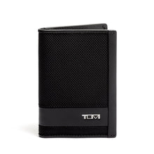 Load image into Gallery viewer, Front panel view of the card case. A small Tumi logo is shown at the bottom right. 
