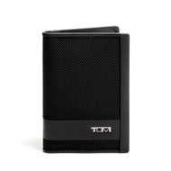 Front panel view of the card case. A small Tumi logo is shown at the bottom right. 