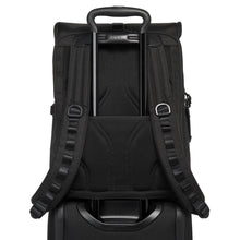 Load image into Gallery viewer, Back panel view of the backpack demonstrating the back strap&#39;s attachment feature attached on a suitcase&#39;s handle. 
