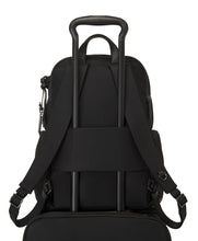Load image into Gallery viewer, Back panel view of the backpack showing the attachment feature. The telescopic handle of a suitcase passes through it to hold the backpack in place. 
