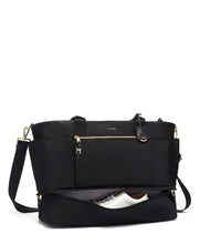 Load image into Gallery viewer, Front panel view of the bag showing a pair of shoes in the unzipped bottom compartment. 
