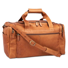 Load image into Gallery viewer, Angled front view of the tan leather duffle bag with the shoulder strap laid across the front.
