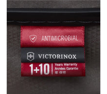 Load image into Gallery viewer, Close up to the three tags inside  the suitcase: One is the antimicrobial tag, then the Victorinox logo, followed by the 1+10 Years Warranty. 
