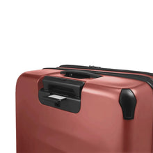 Load image into Gallery viewer, Angled close up to the back of the suitcase. Under the telescopic handle, a hidden panel has a Name and Contact Information tag. 
