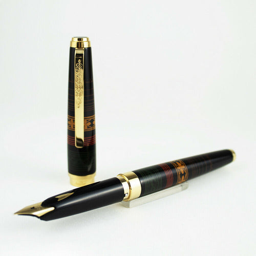 The fountain pen with the cap next to it arranged on a white background. 