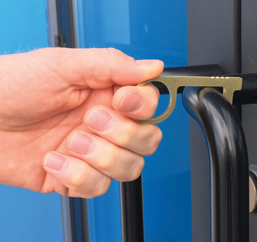 A hand holding the key grip to open a door by pulling it from the handle. 