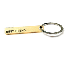 Load image into Gallery viewer, A rectangular brass colored key chain on a key ring with the phrase BEST FRIEND. The back definition is: : (noun) Sharer of wine, caller of truth. Always there for me. Obligated to listen to me gripe. See also: crew, grateful, good times.
